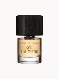 Flakon des Parfums Sol Salgado Extrait de Parfum von Thomas de Monaco mit hellem Duftinhalt und elegantem, schwarzem Holzverschluss.